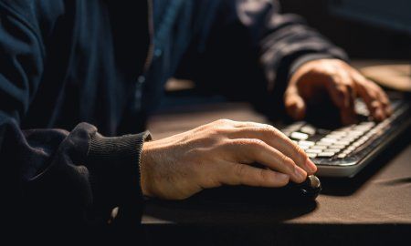 Photo Of Male Hacker Typing On Keyboard