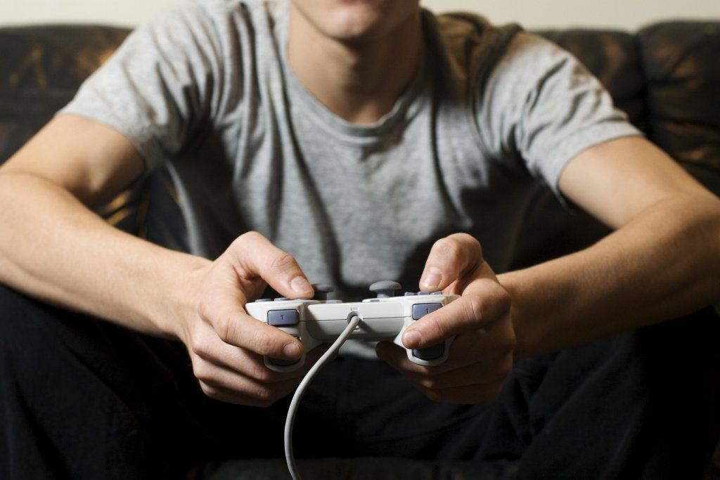 Young Man Holding Video Game Control