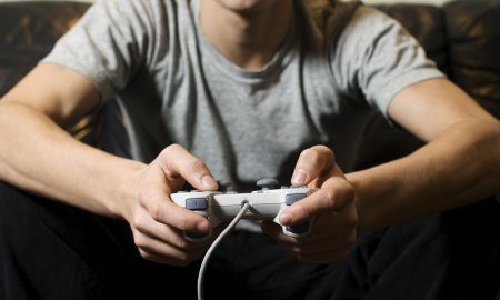 Young Man Holding Video Game Control