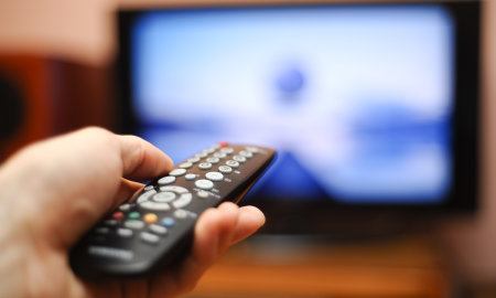Watching Tv And Using Remote Controller