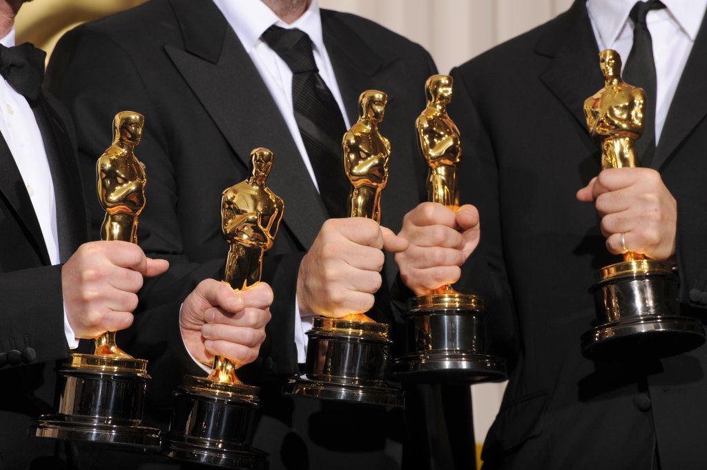 Hands holding Oscars