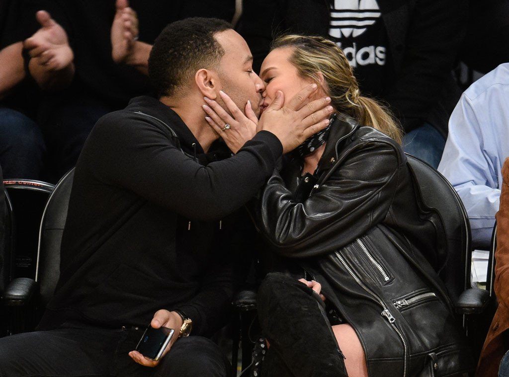 John Legend and Chrissy Teigen kiss for Jumbotron