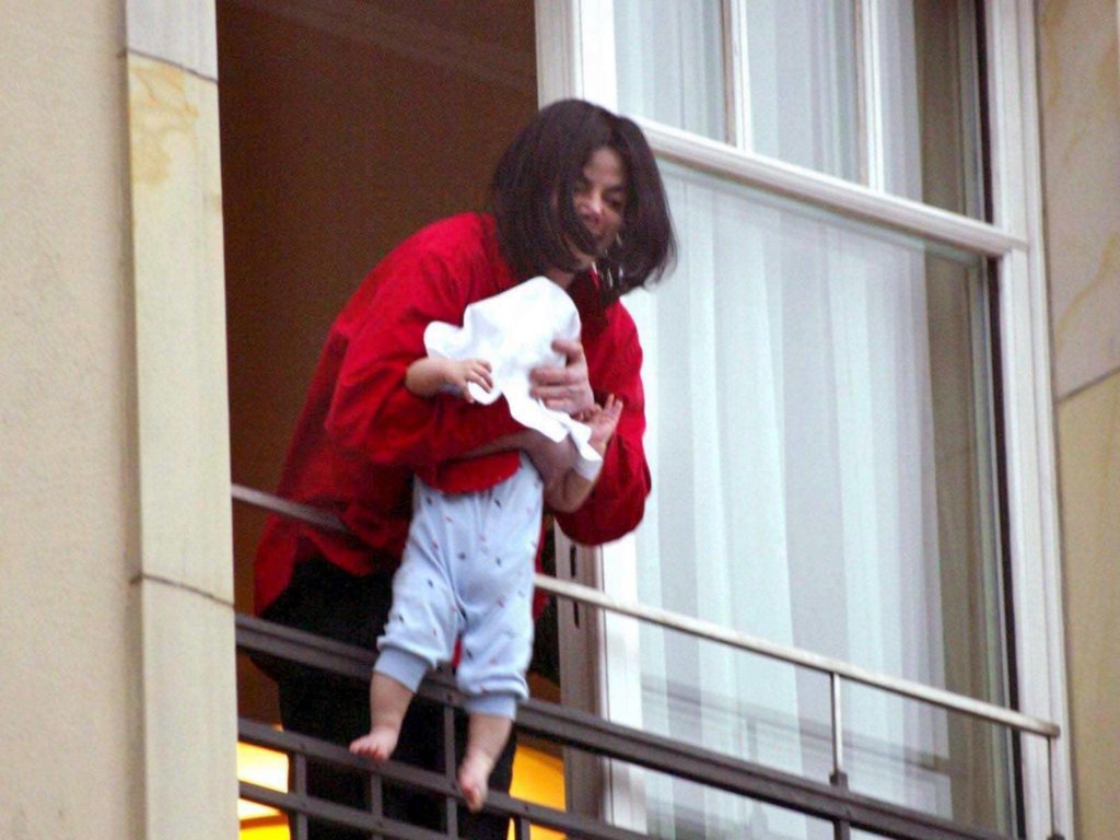 Michael Jackson Dangles Baby