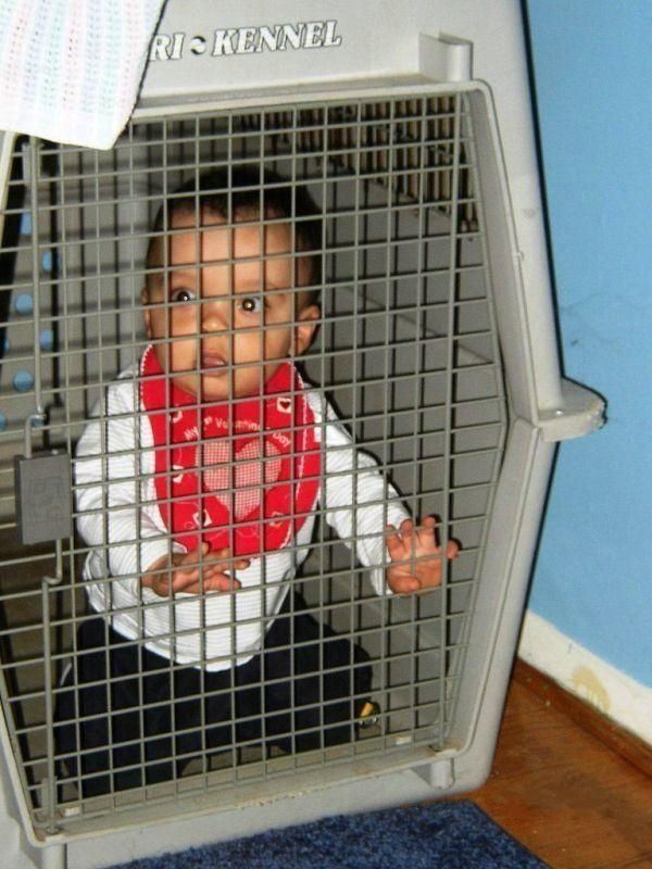 Baby in a dog cage